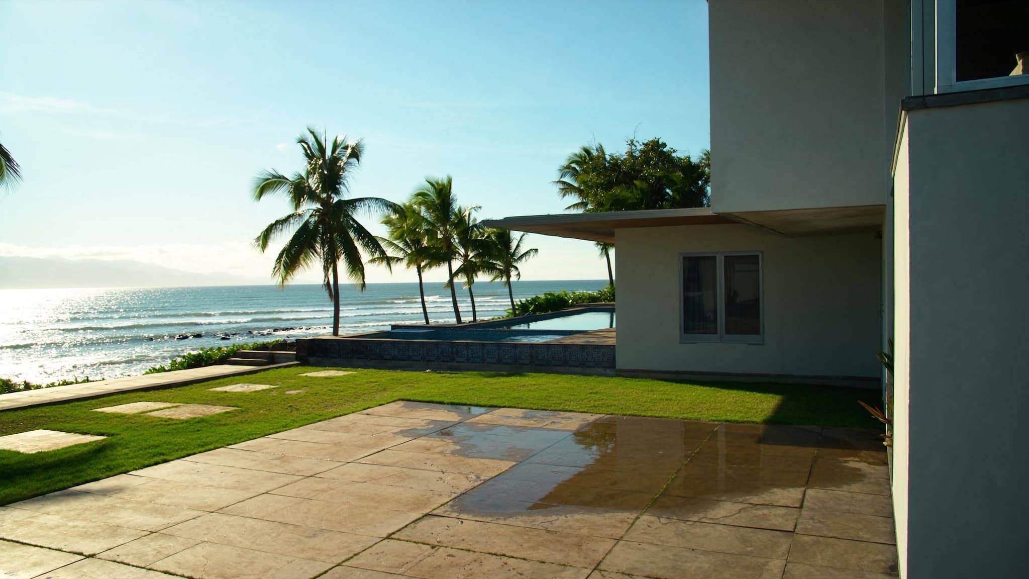 Modern oceanfront estate with an infinity pool on Maui, Hawaiʻi at golden hour